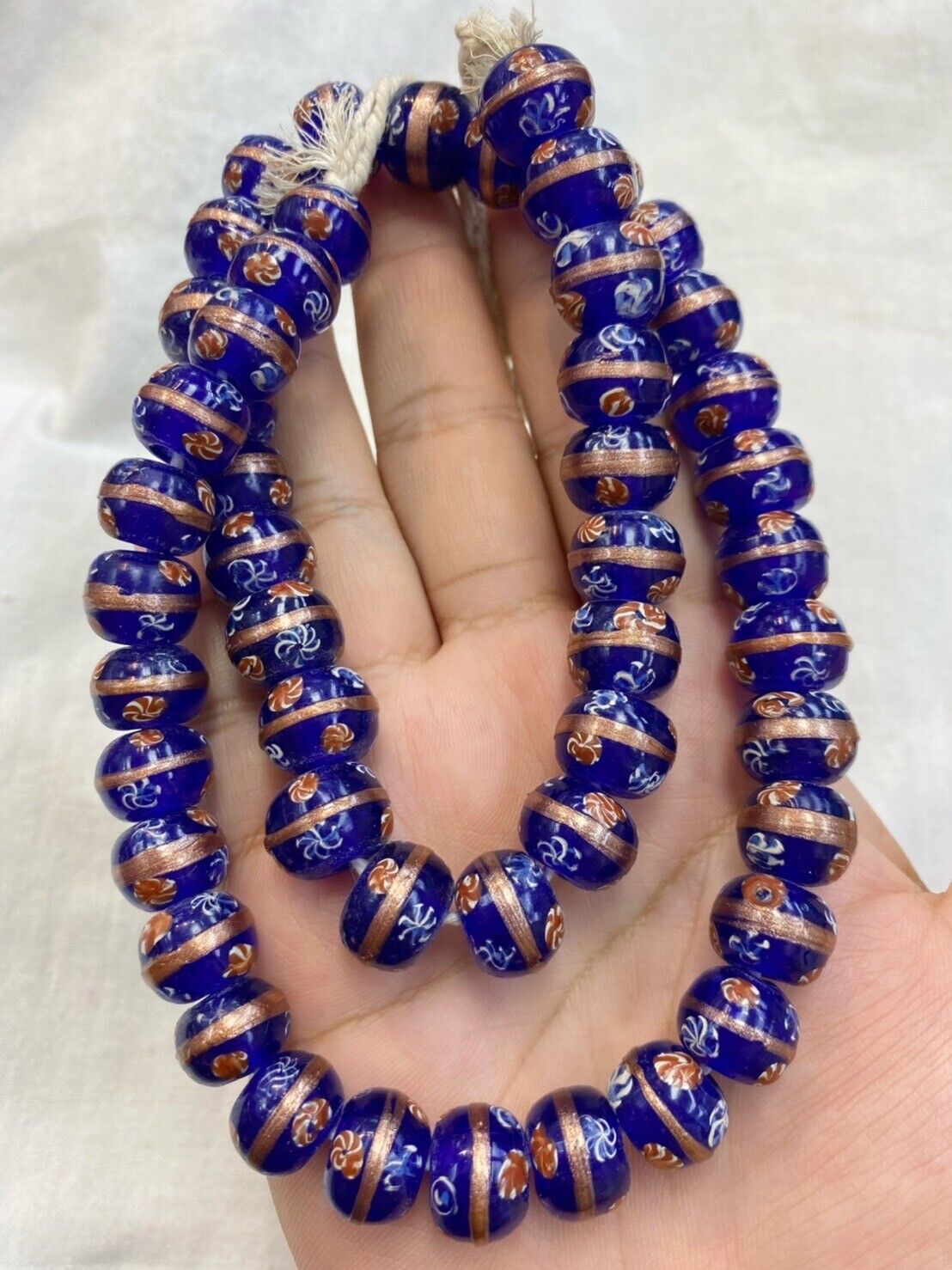 "Vintage Murano Millefiori art glass beaded strand, featuring beautiful and intricate 13MM glass beads in a vibrant, multi-colored design. Measuring 52CM long, this stunning piece showcases the renowned craftsmanship of Murano glassmakers and is a true treasure for collectors of vintage jewelry and art glass."