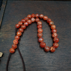 "Vintage Himalayan Tibetan necklace featuring faceted carnelian agate beads, expertly cut to reveal their warm, earthy tones and subtle patterns. Each bead is a testament to traditional Tibetan craftsmanship, making this necklace a unique and treasured possession."