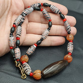 "YMN3: A vibrant and eclectic necklace featuring a combination of Indo-Tibetan Himalayan Agate and glass beads, showcasing a unique blend of traditional craftsmanship and cultural heritage. The Agate beads add a touch of earthy elegance, while the glass beads inject a pop of color and vibrancy, making this necklace a true statement piece."