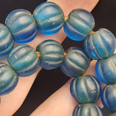 "Vintage African blue glass beads, showcasing a beautiful and vibrant color, with an antique patina and unique character, reflecting the rich cultural heritage and traditional craftsmanship of African beadwork."