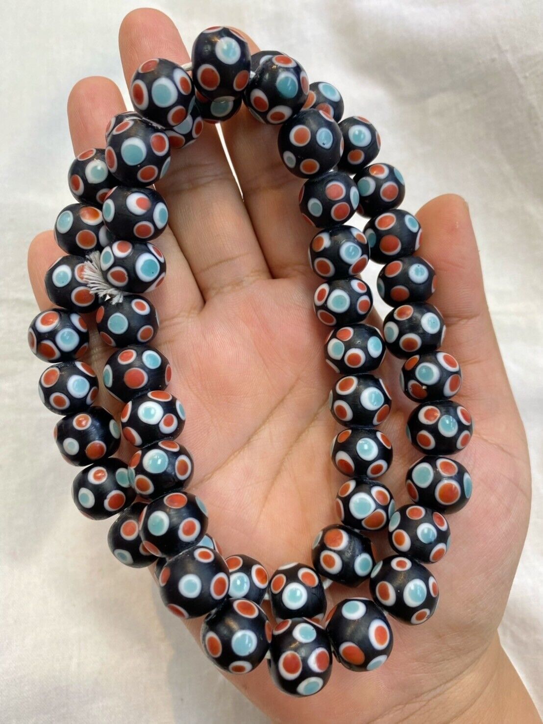 "Vintage Skunk hundred eyes glass beads, approximately 14MM in size, with a total of around 90 beads. These unique beads feature a distinctive 'hundred eyes' design, adding a touch of nostalgia and charm to any jewelry piece or craft project."