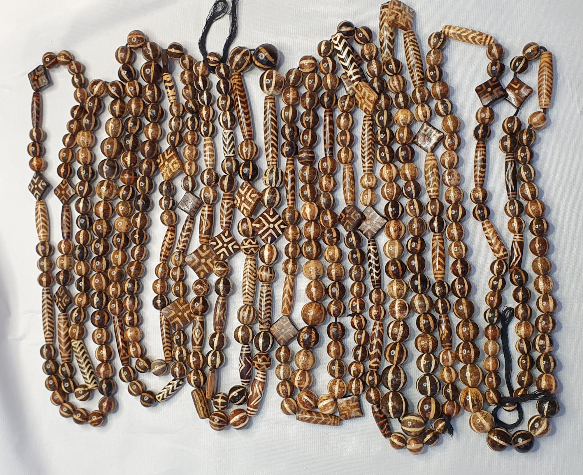 Antique Tibetan dzi beads and trade beads on a dealer's table