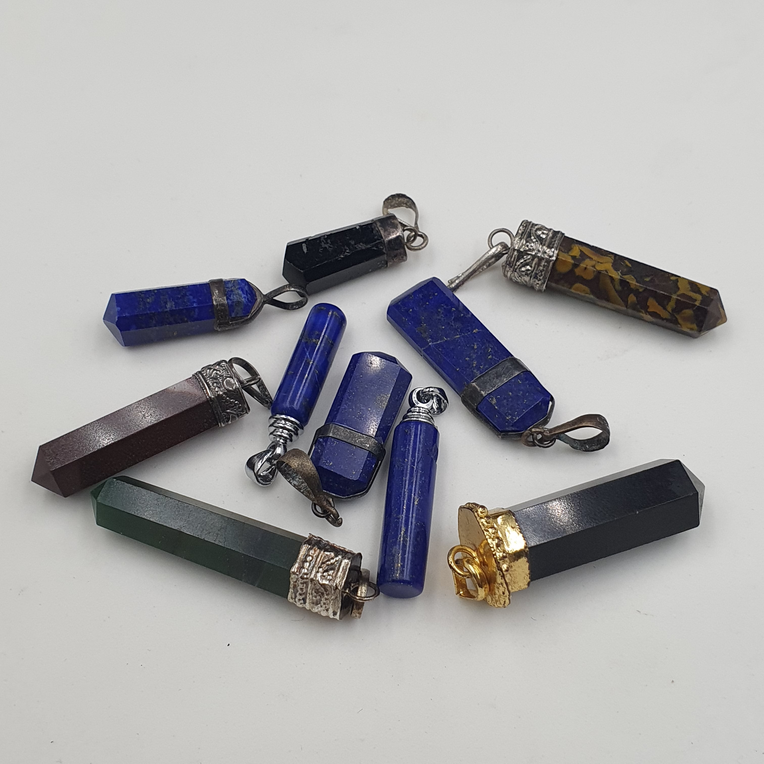 Mix of natural gemstone pendants including agate, jade, jasper, and more