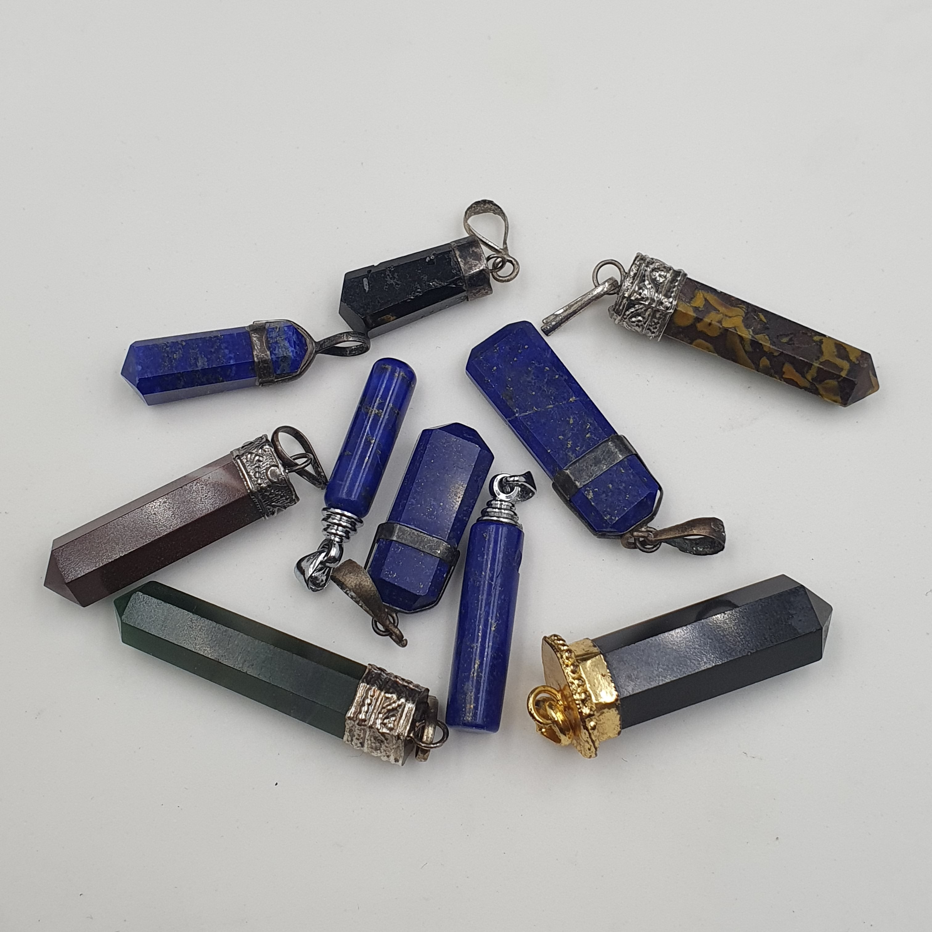 Mix of natural gemstone pendants including agate, jade, jasper, and more