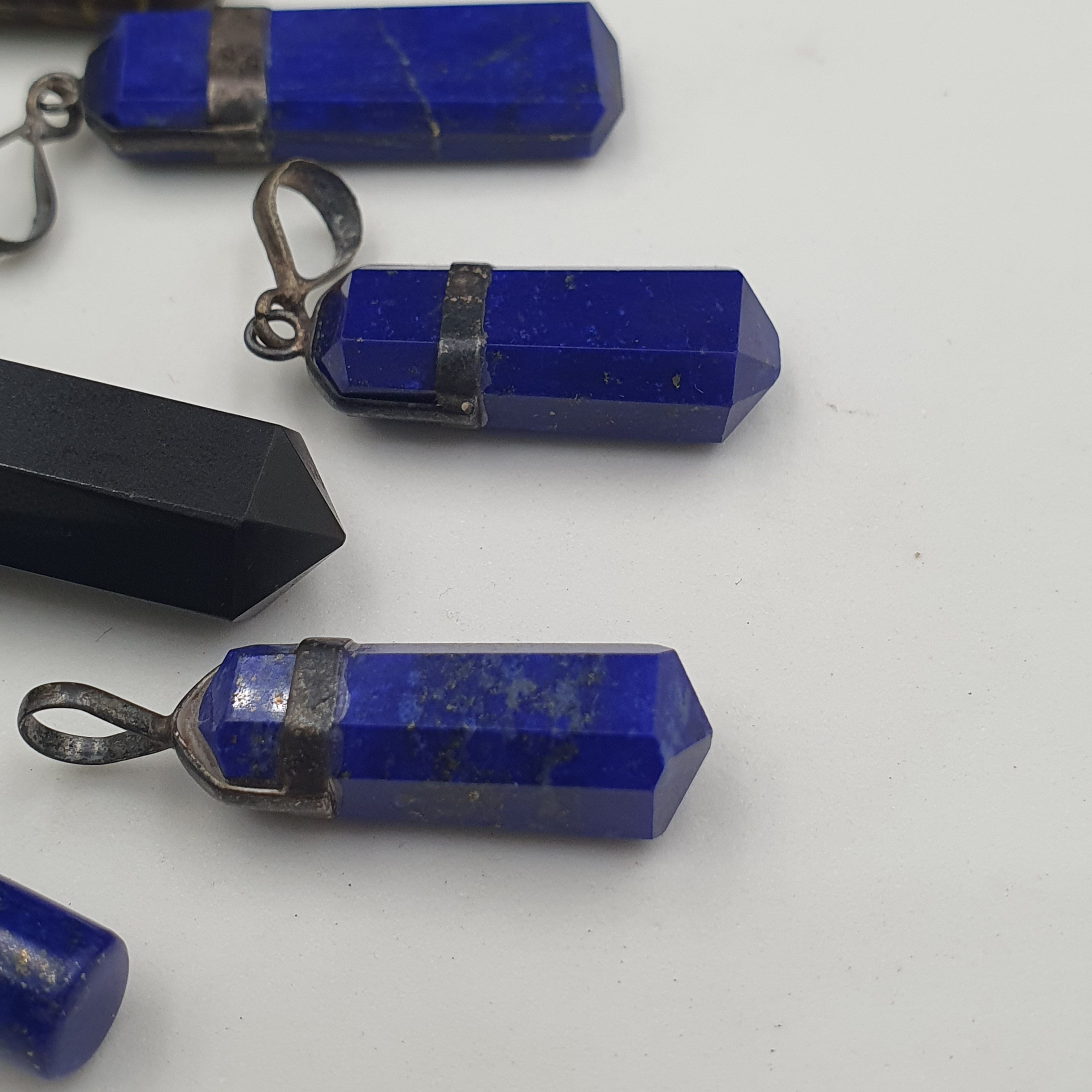 Mix of natural gemstone pendants including agate, jade, jasper, and more