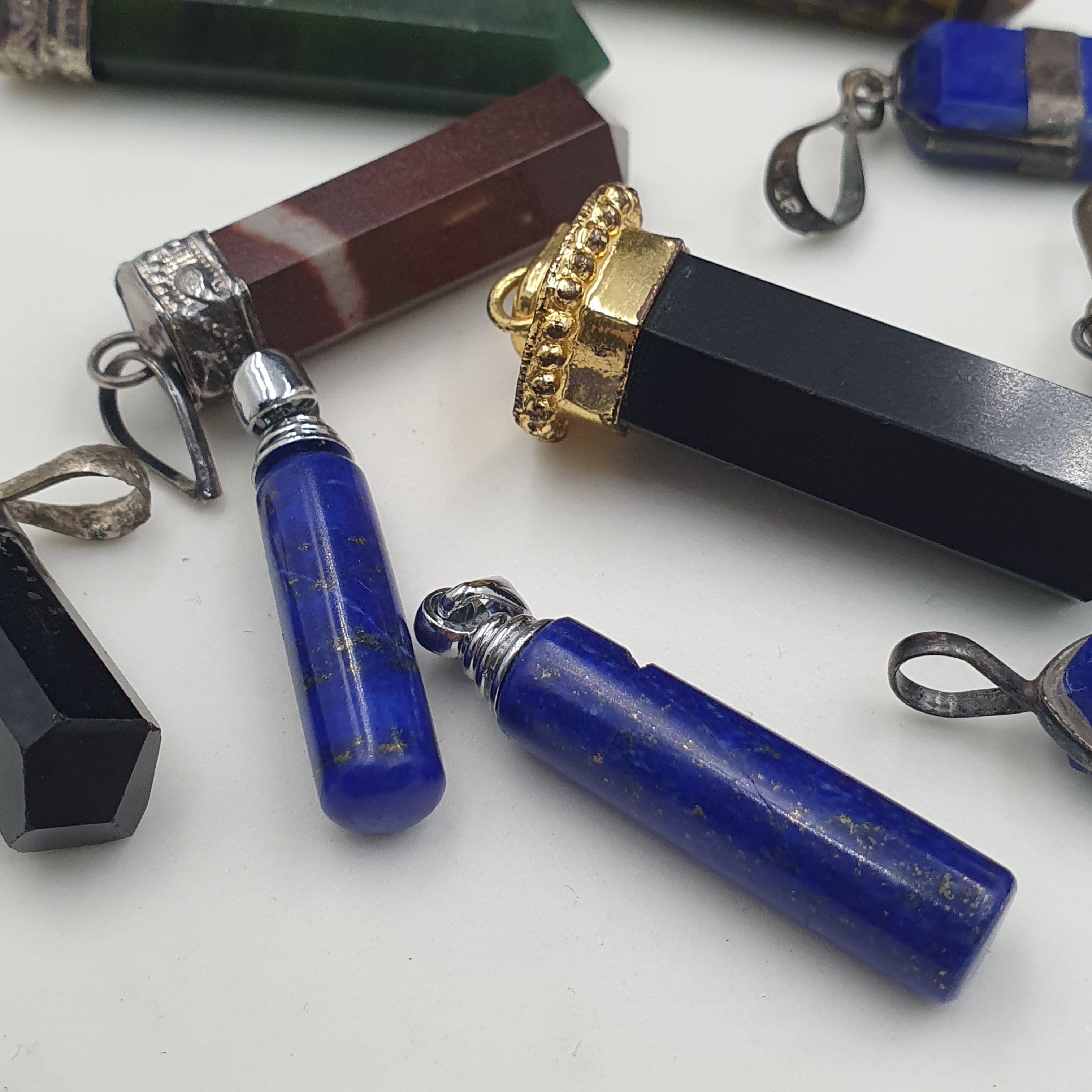 Mix of natural gemstone pendants including agate, jade, jasper, and more