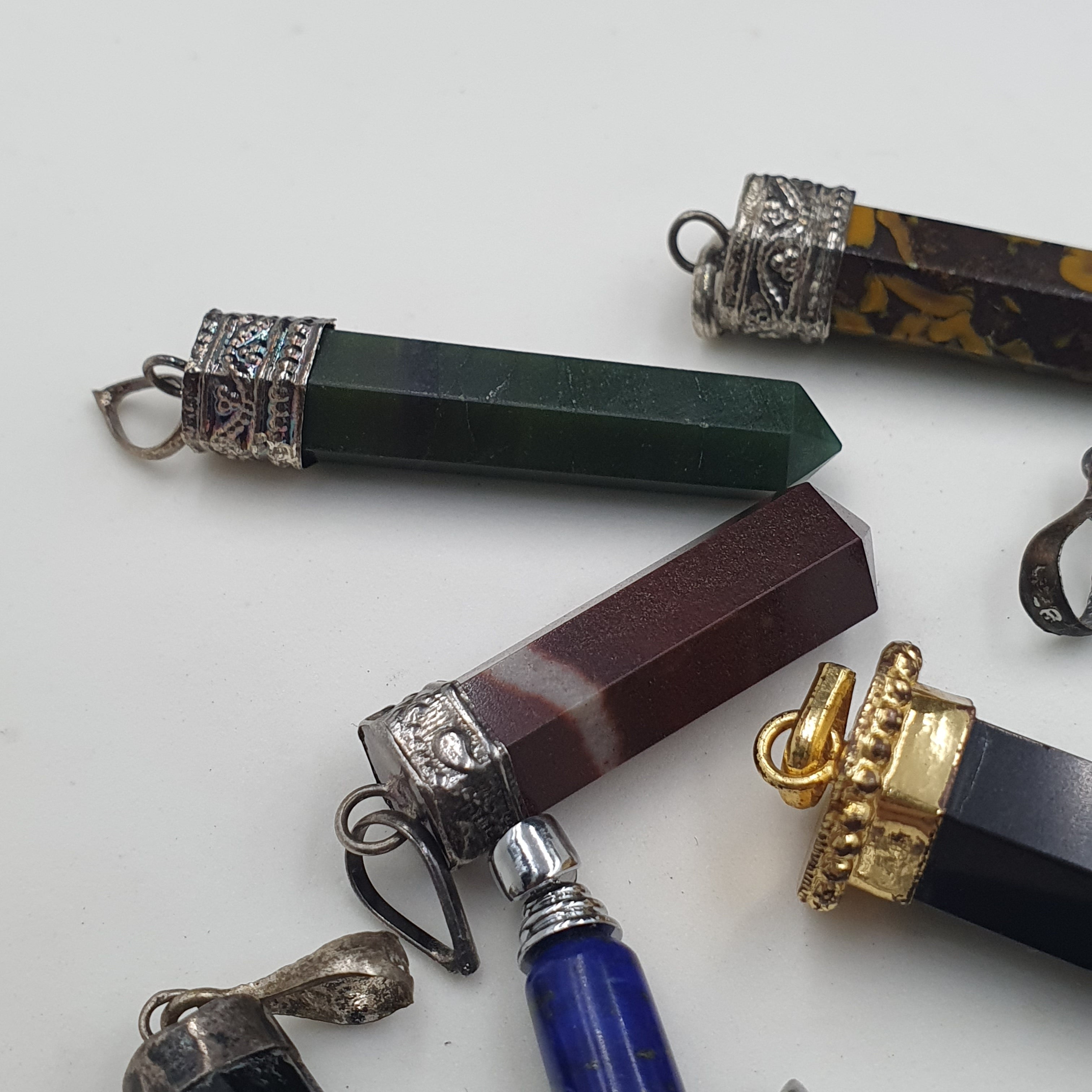 Mix of natural gemstone pendants including agate, jade, jasper, and more