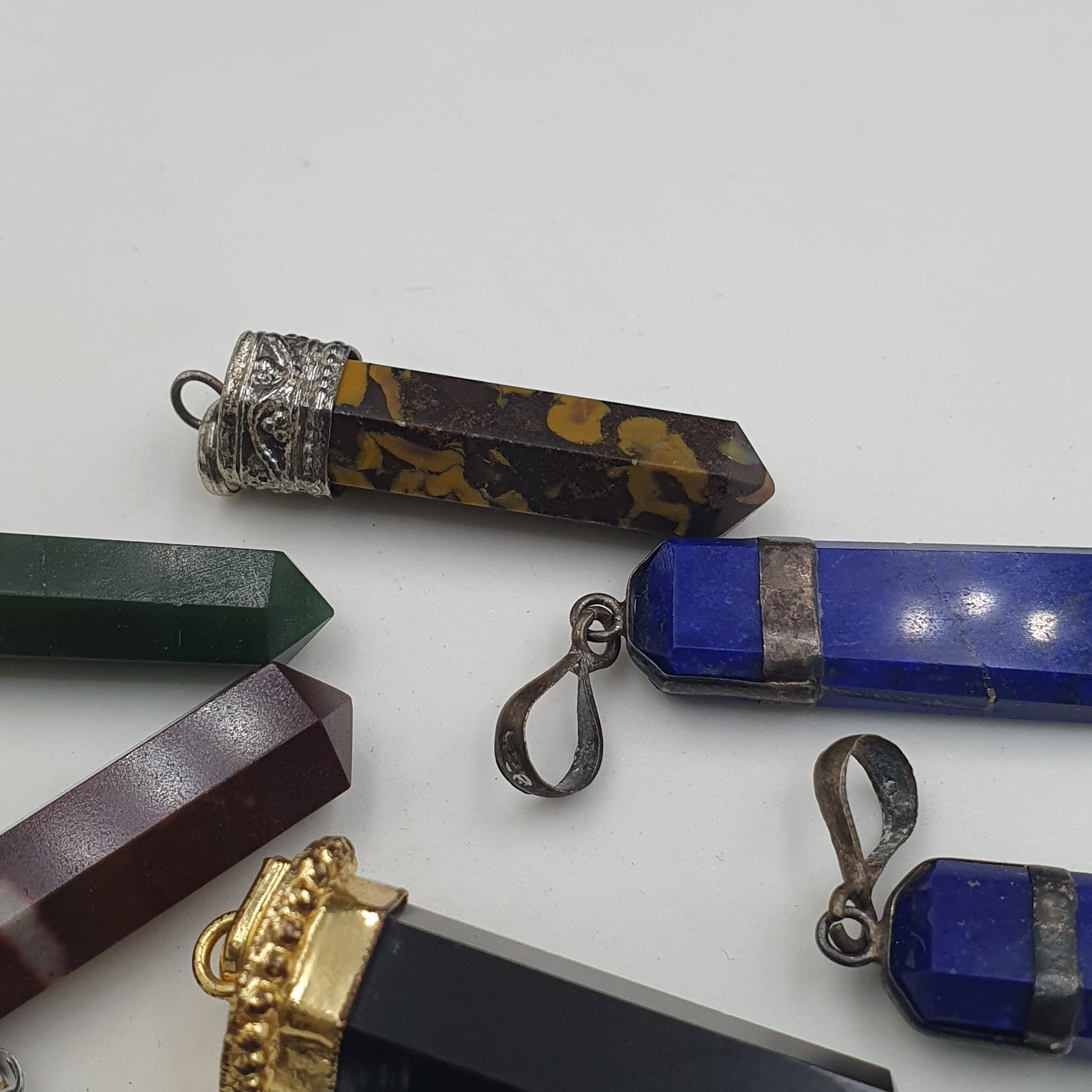 Mix of natural gemstone pendants including agate, jade, jasper, and more