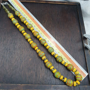 Necklace shown beside a measuring tape