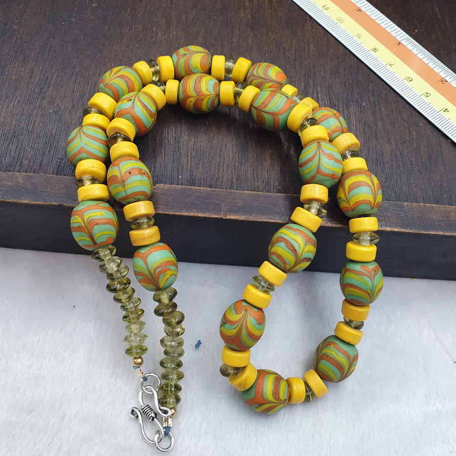Handmade multicolor beaded necklace laid out for a full view