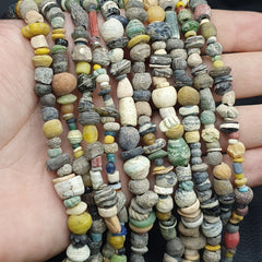 "RM-2: A stunning authentic ancient strand necklace from the Islamic Roman Era, featuring six strands of expertly crafted beads. Each bead tells a story of a bygone era, showcasing intricate designs and patterns that have stood the test of time. A true treasure for collectors and history enthusiasts, this necklace is a rare and precious find."