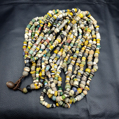 "Rare and authentic strand necklace featuring ancient beads from the Islamic Roman Era, showcasing intricate craftsmanship and historical significance. Each bead tells a story of a bygone era, making this necklace a true treasure for collectors and history enthusiasts."