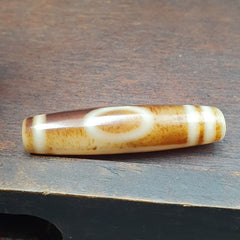This exquisite vintage Indo Tibetan Agate Stone showcases a rare one-eye pattern, embodying the rich cultural heritage of the region. Meticulously handcrafted, this pure agate stone exudes timeless beauty and historical significance. Its unique markings tell a story of ancient 