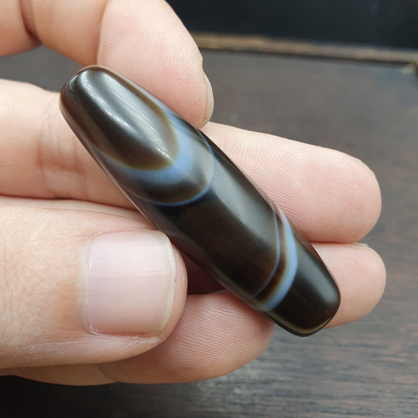 Antique Yemeni collectible agate bead showcasing natural banded pattern. Unique vintage jewelry piece with historical significance.