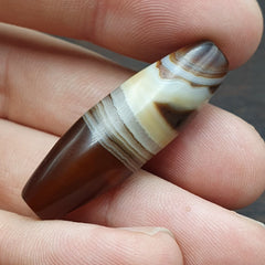 Antique Yemeni Collectible Agate Bead showcasing Nature's Signature Banded Agate , a rare and exquisite gemstone with intricate natural patterns, perfect for collectors and jewelry enthusiasts.