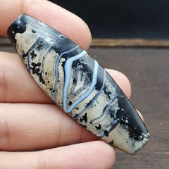 Antique Agate Bead boasting a mesmerizing Eye pattern and adorned with a breathtaking Patina that tells stories of centuries past. Crafted with meticulous artistry, this piece is a testament to the ancient allure of agate, capturing the imagination with its intricate details and rich history. Let its beauty enchant you as you delve into the mysteries of the past, each glance revealing a new facet of its captivating charm.