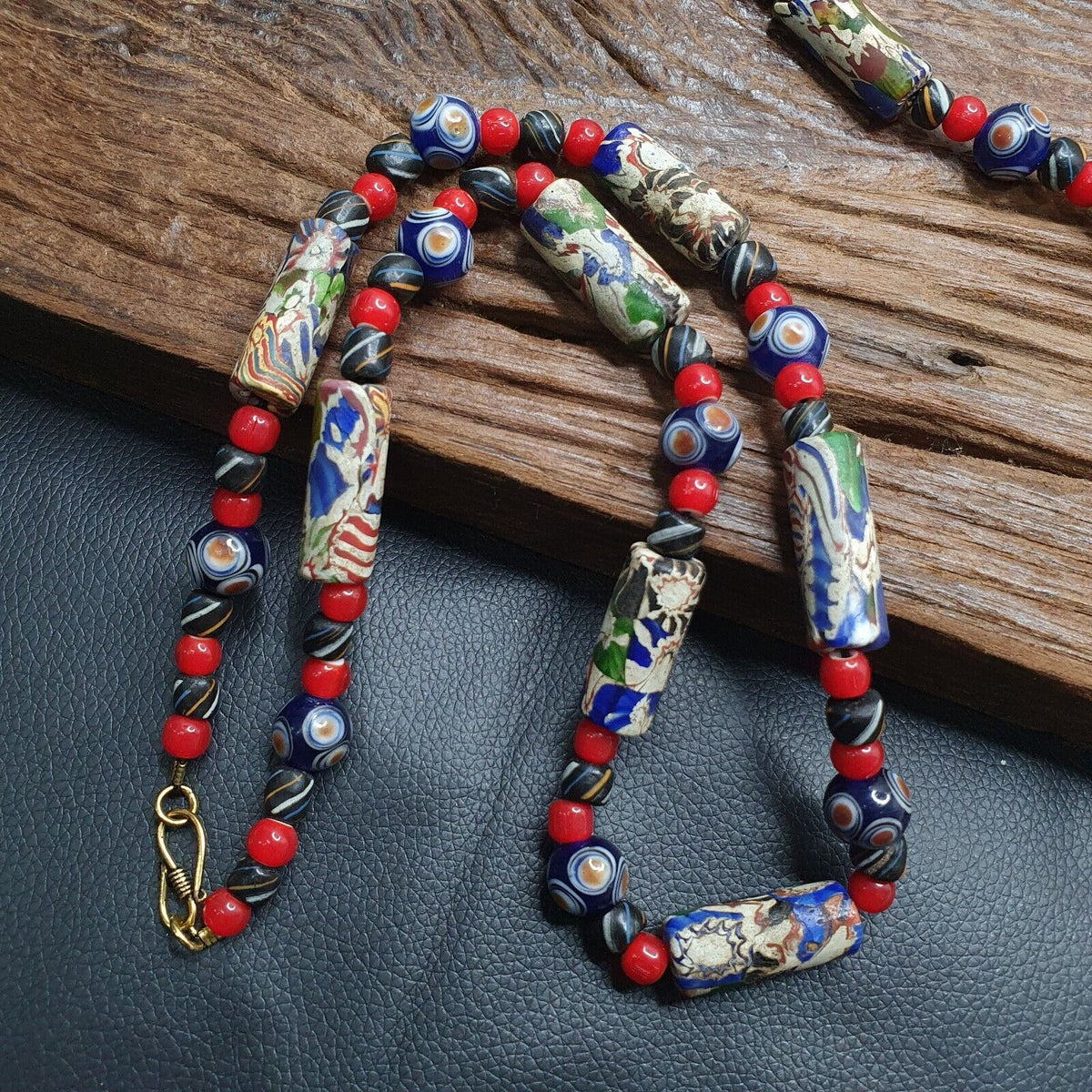  Venetian Millefiori Style beads necklace, meticulously crafted to captivate hearts and turn heads. Each bead is a masterpiece, boasting intricate designs reminiscent of the famed glasswork of Murano.  Handpicked for their vibrant hues and delicate patterns, these Venetian Millefiori Style beads showcase the rich heritage of Venetian artistry. From floral motifs to geometric patterns, each bead tells a story of tradition and craftsmanship passed down through generations.