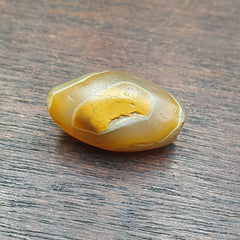 Rare Himalayan agate bead, featuring intricate patterns and hues of gray, from the Ancient Suleimani collection. A prized artifact, showcasing the beauty of natural geological formations and historical craftsmanship.