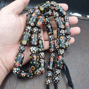 Vintage black gabri eyes skunk thousand eyes glass beads strand.
