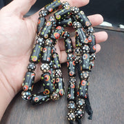 Vintage black gabri eyes skunk thousand eyes glass beads strand.
