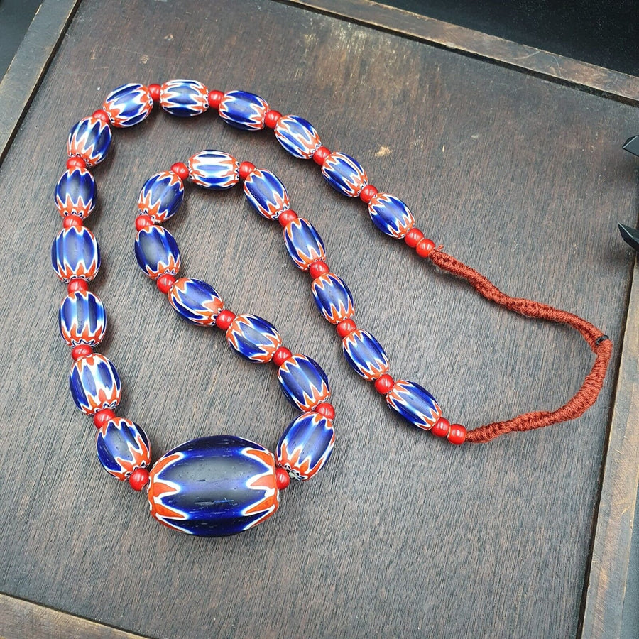Antique white heart venetian inspired african blue glass chevron with big bead.