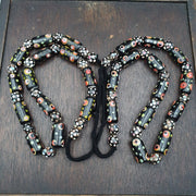 Vintage black gabri eyes skunk thousand eyes glass beads strand.