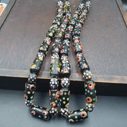 Vintage black gabri eyes skunk thousand eyes glass beads strand.