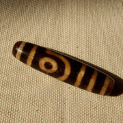 Tibetan two eye dzi bead in cinnamon eyes agate – photo 3 of 5