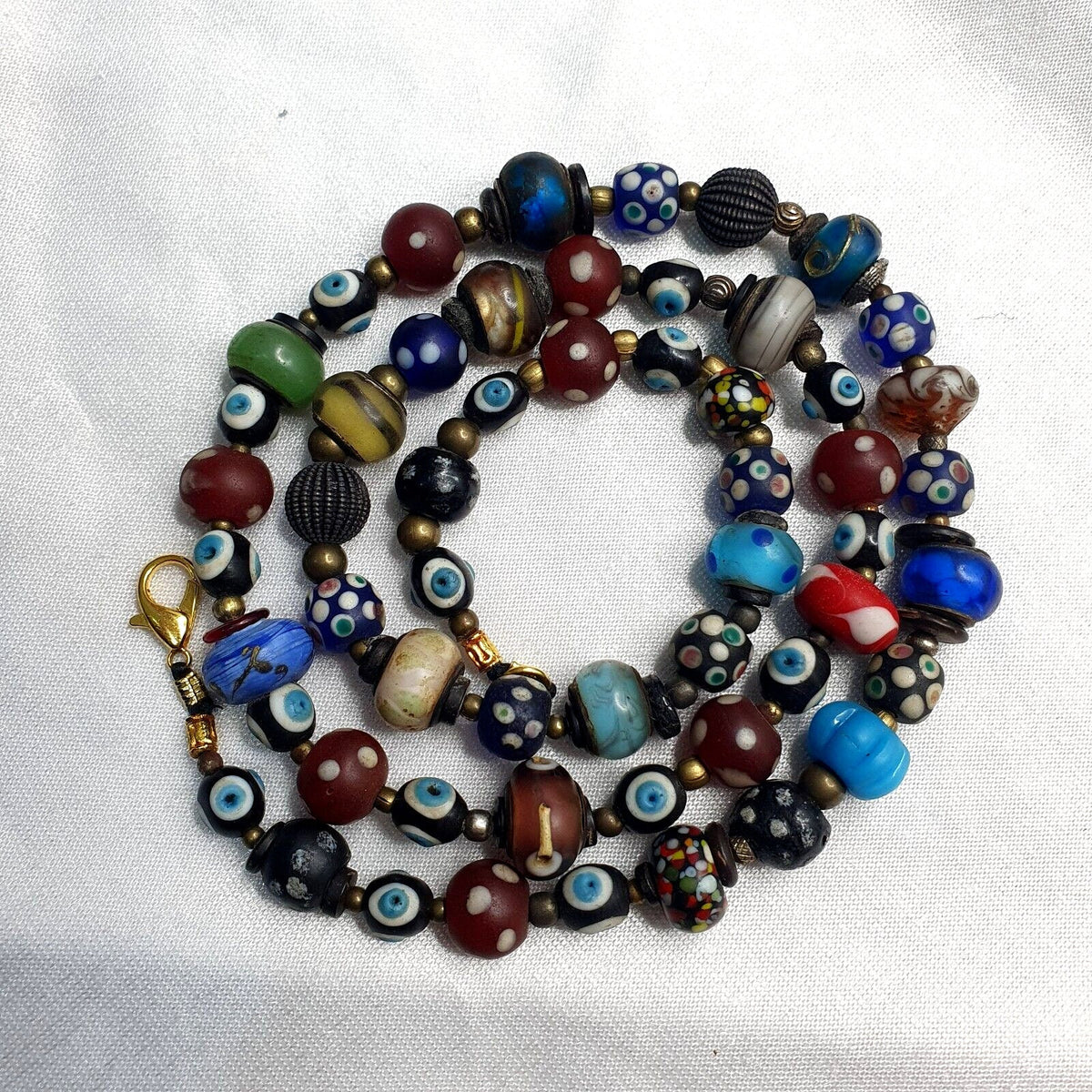 Vintage beads collection skunk, evil eye, blown glass beaded necklace.