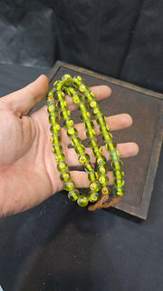 Greenish tint small yellow smiley faces venetian inspired beads strand