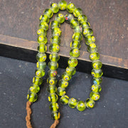 Greenish tint small yellow smiley faces venetian inspired beads strand