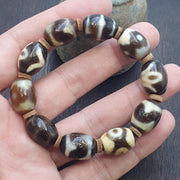 Tibetan dzi-style bead bracelet mala with eye and wave motifs – photo 2 of 5