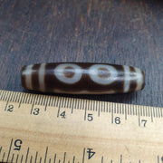 Tibetan-style 3 eye dzi bead in weathered banded agate – photo 3 of 5