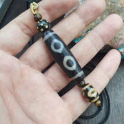 Tibetan-style 3 eye dzi bead with rustic dragon skin weathering – photo 5 of 5