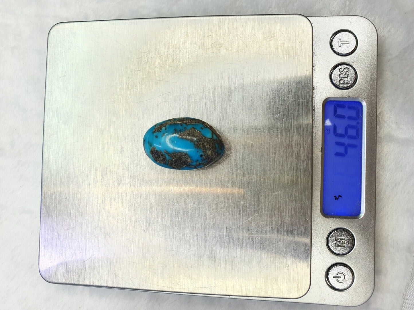 一顆橢圓形正宗天然綠松石，帶黃鐵礦基質凸圓面 46 克拉