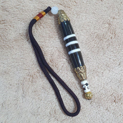 "Image of a unique Tibetan silver Nepalese dzi bead pendant necklace, featuring 3 striped lines on an agate bead, believed to bring spiritual protection and good fortune in Tibetan Buddhism, making a beautiful and meaningful addition to any jewelry collection."